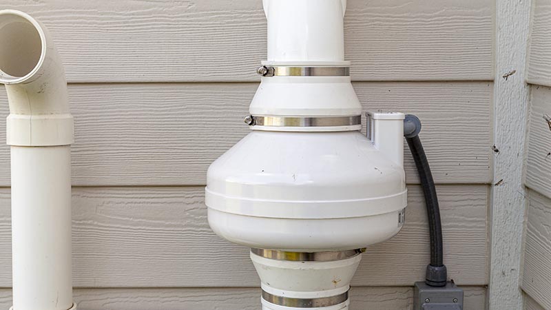 residential radon mitigation system being checked while performing home inspection services